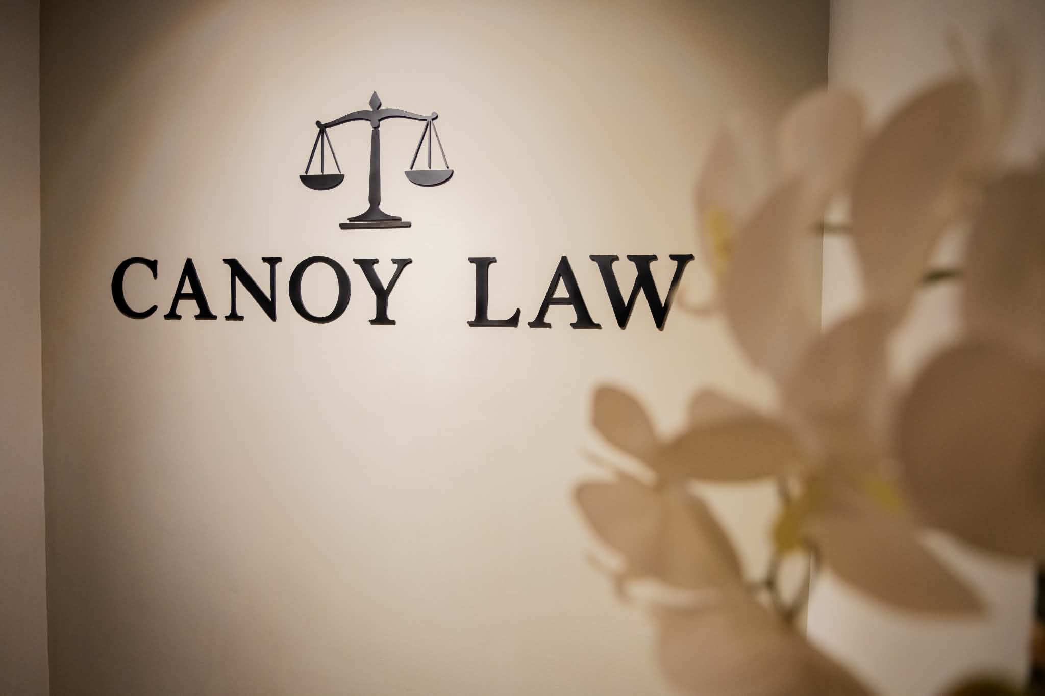 Canoy Law wall sign with scales of justice